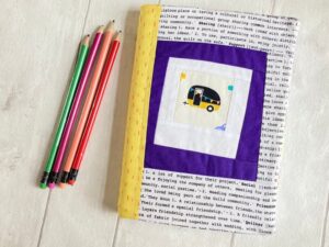a cute caravan picture on a notebook with yellow binding