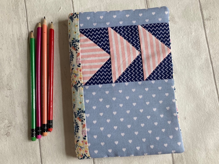 a Light blue notebook cover with pink triangles