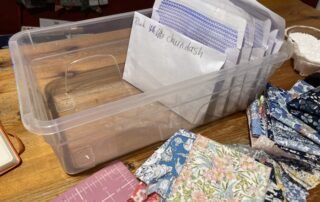 A box of envelopes with fabric in