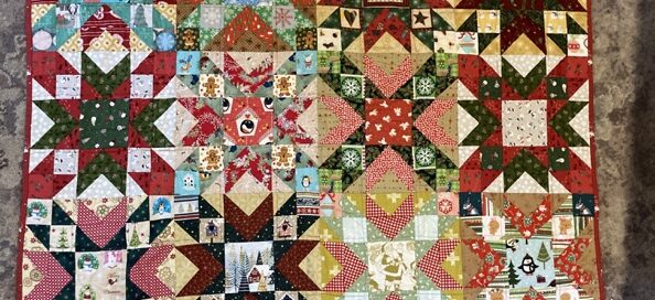 lots of stars and a truly scrapy looking red/goldgreen quilt top