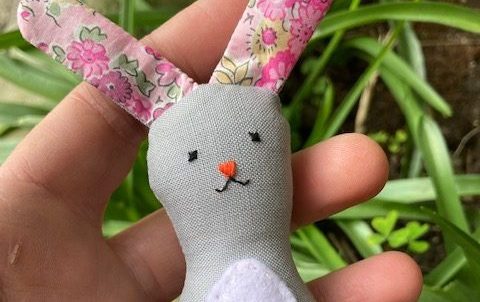 Tiny Bunny is grey and has pink floral fabric ears