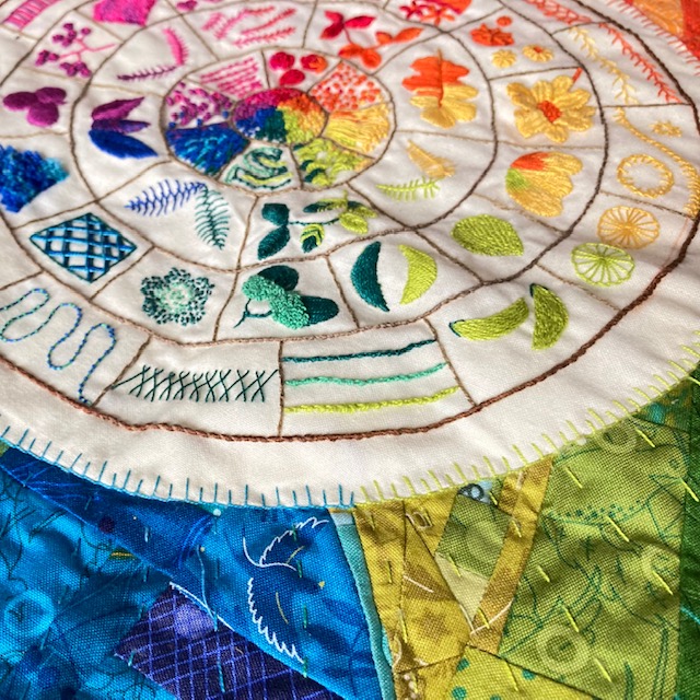 A close up of the rainbow embroidered stitch wheel