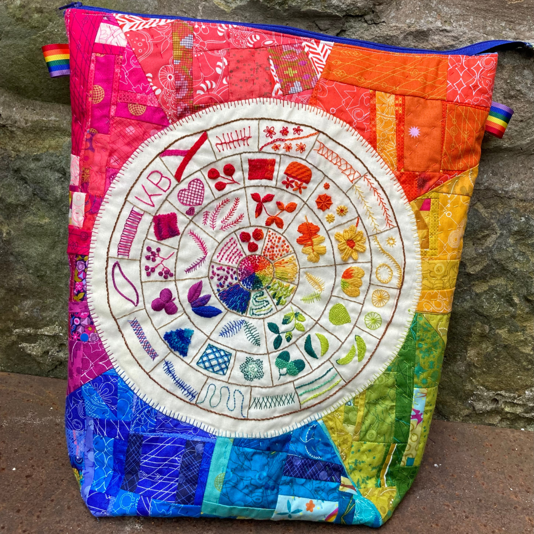 A Bright Rainbow pouch that has an embroidered stitch wheel on