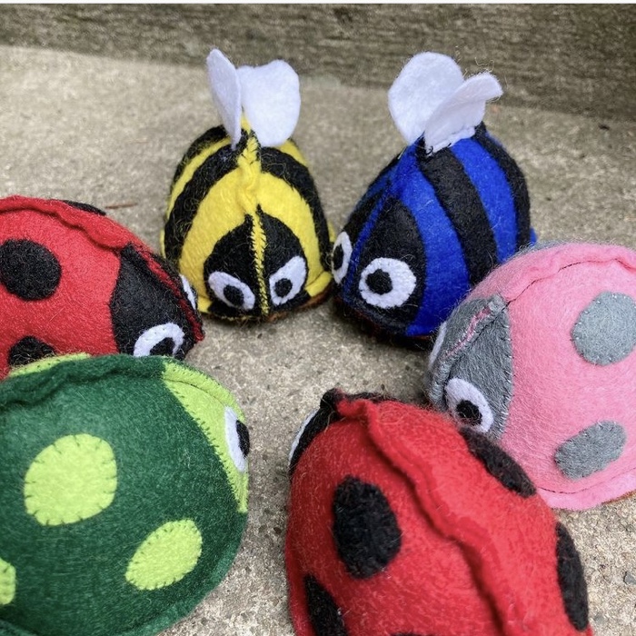 6 handmade felt bugs all looking at each other