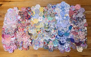 A Collection of Liberty fabric Hexagon Flowers - the colour of the rainbow