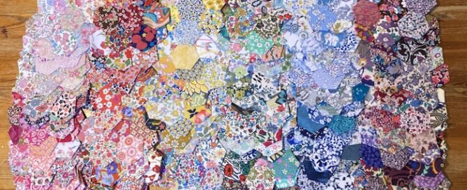 A Collection of Liberty fabric Hexagon Flowers - the colour of the rainbow
