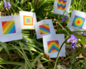 Tiny Rainbow Cross stitch squares in grass