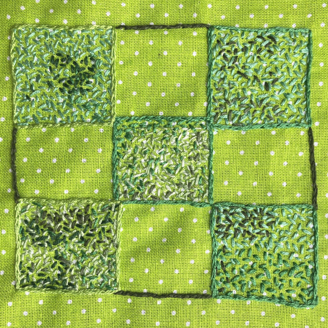 A green 0&X's board using the seed stitch