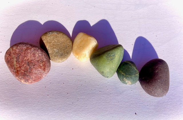 A rainbow pebble collection
