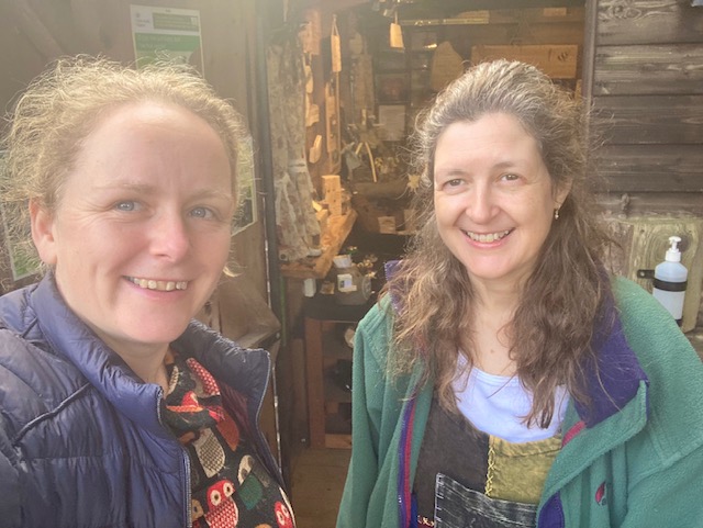 Karen and Nikki smiling in front of the Shop in a Shed