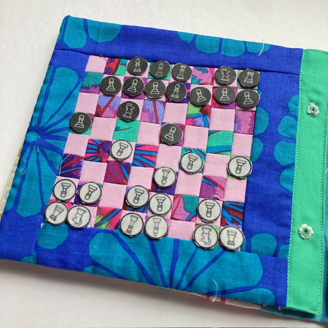 a chess board made in patchwork fabric